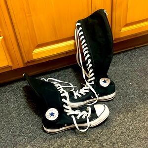 Woman’s extra high top converse.